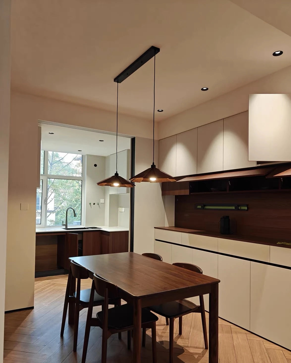 Pendant arrangement in a wood-furnished dining area